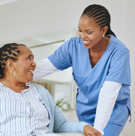 image: Elderly woman and nurse smiles