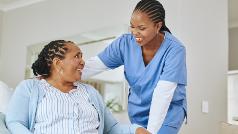 image: Elderly woman and nurse smiles